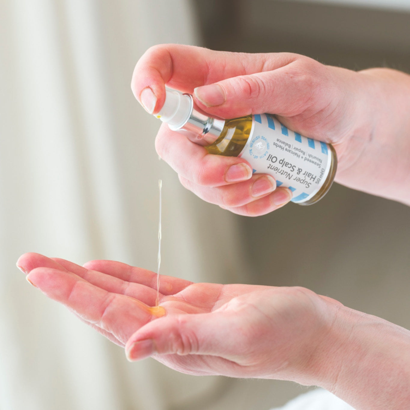 Bottle of super-nutrient hair and scalp oil with natural ingredients for healthy, shiny hair and scalp nourishment.