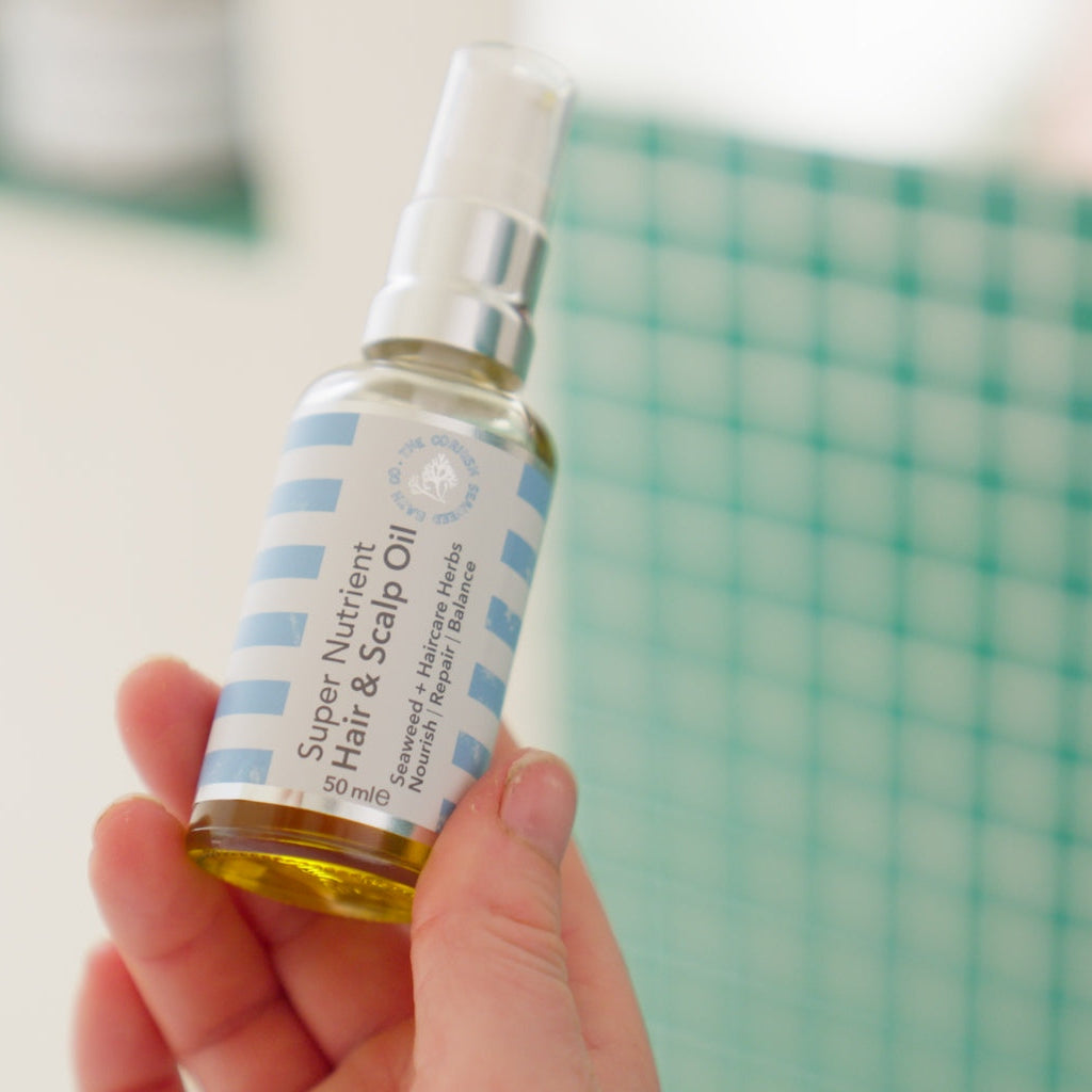 Bottle of super-nutrient hair and scalp oil with natural ingredients for healthy, shiny, and revitalized hair care.